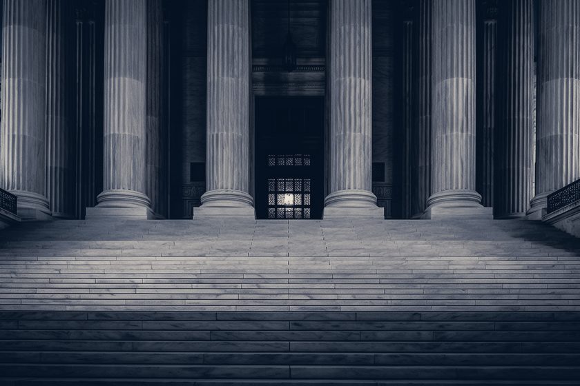 Courthouse steps and columns lit at night